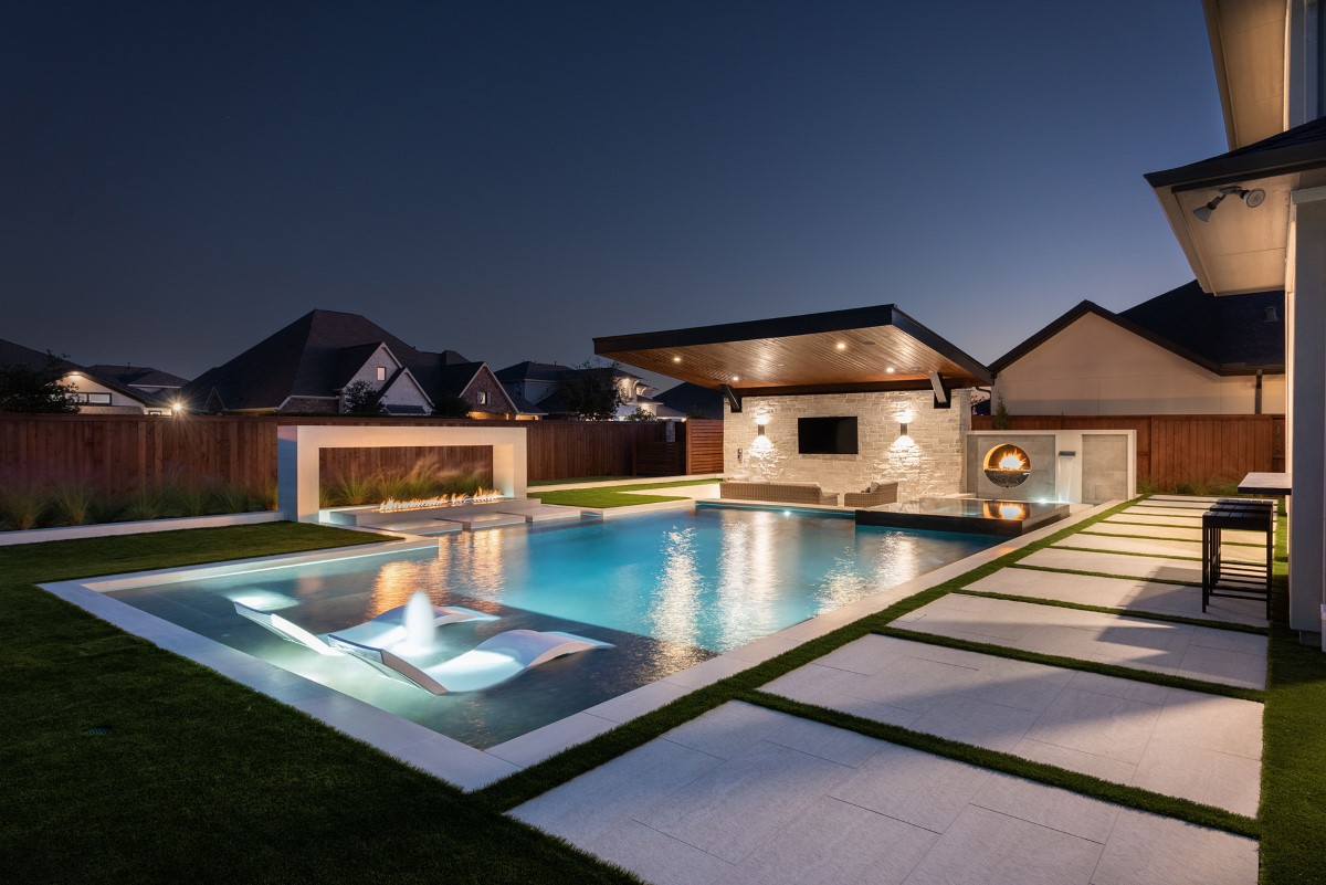 Custom pool build in Austin with spa, fire feature and modern patio