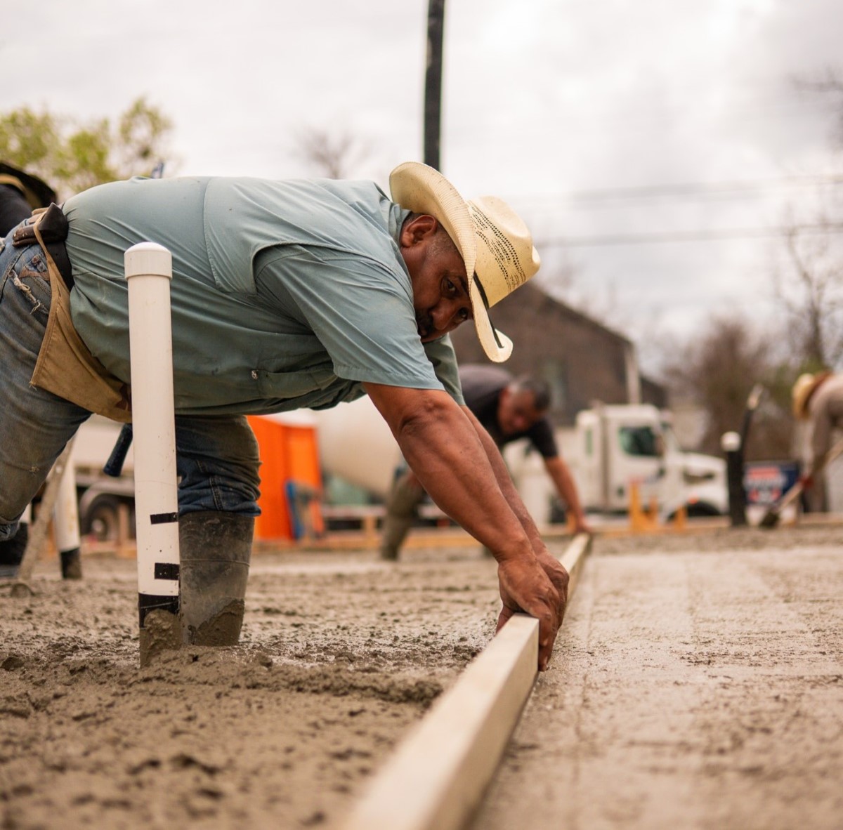 Austin pool builder installing custom pool edge piping on construction site