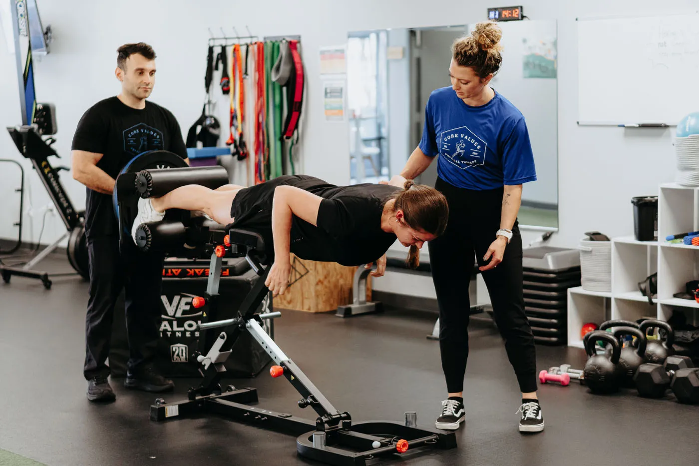 Patient performing a back extension supervised by a physical therapist
