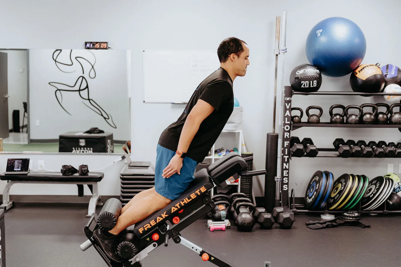 Patient performing back extensions on a Freak Athlete bench during physical therapy
