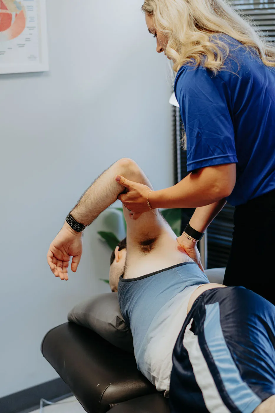Physical therapist performing shoulder joint manual therapy on a patient