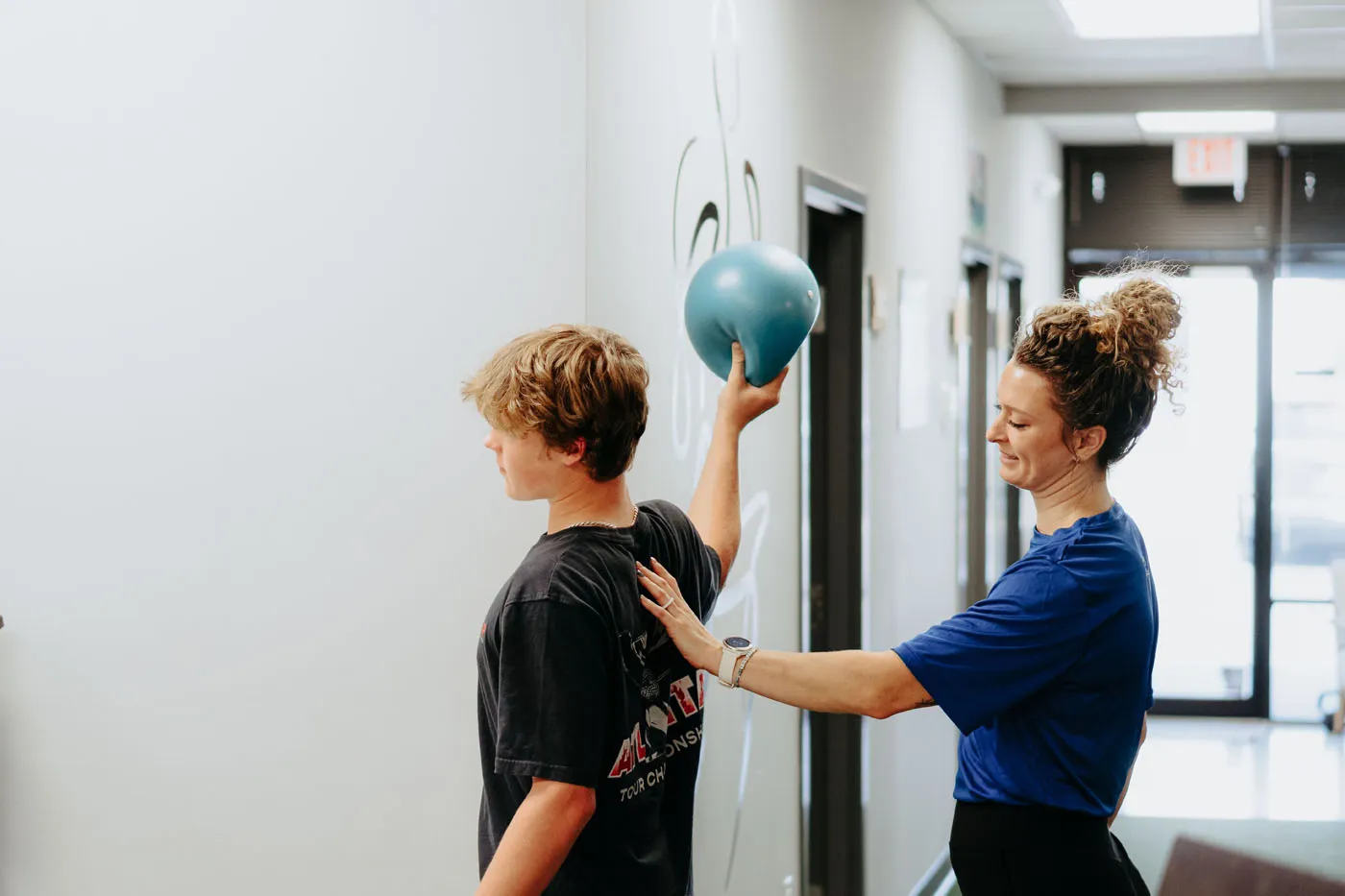 Patient performing an overhead ball throw during physical therapy