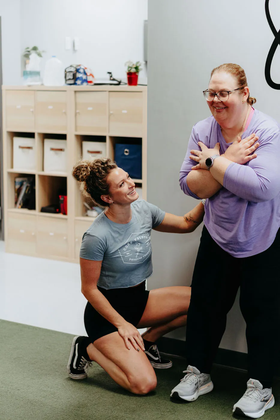 Patient performing a shoulder exercise while kneeling during physical therapy
