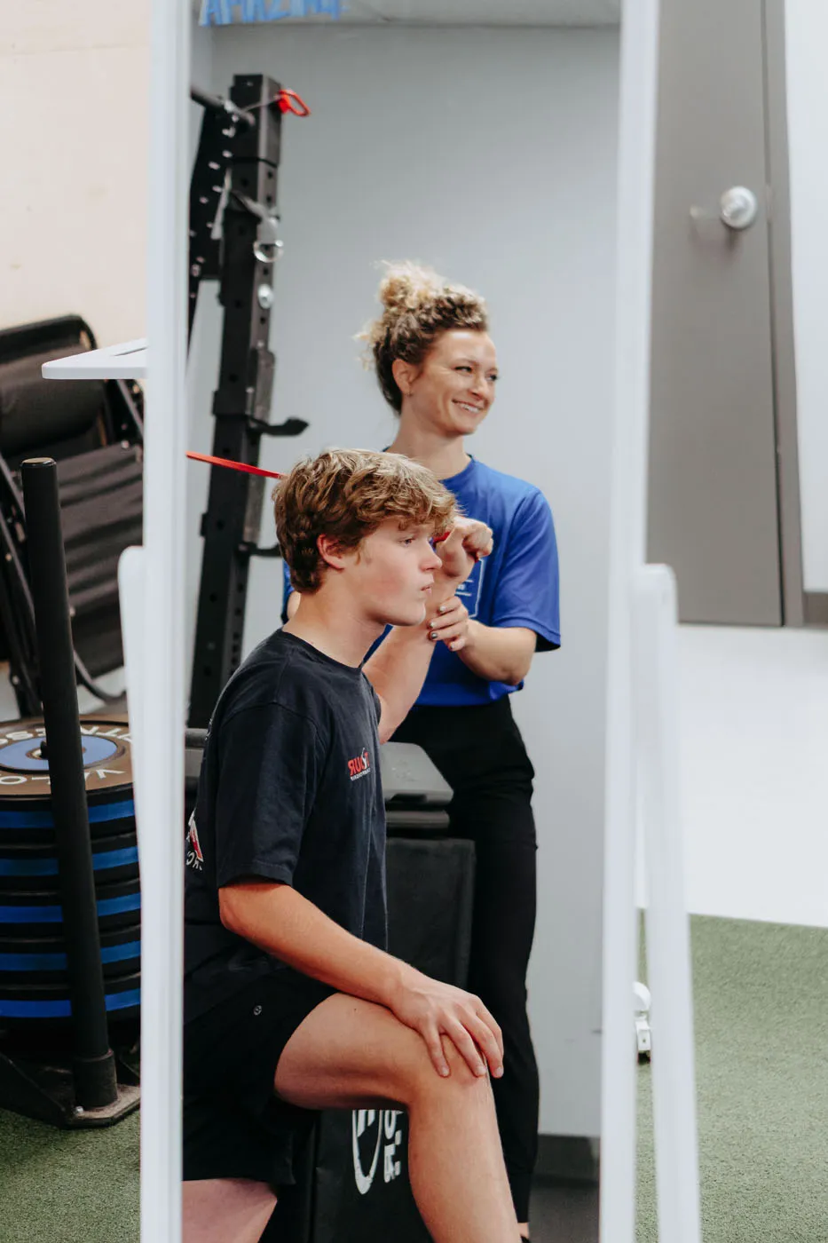 Physical therapist performing a postural assessment on a patient
