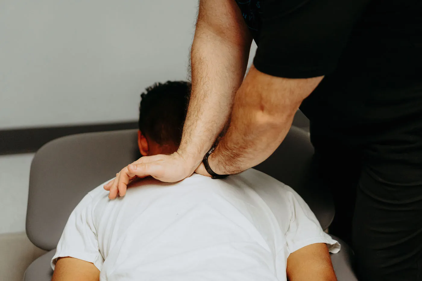 Closeup of cervical manual therapy being performed on a patient