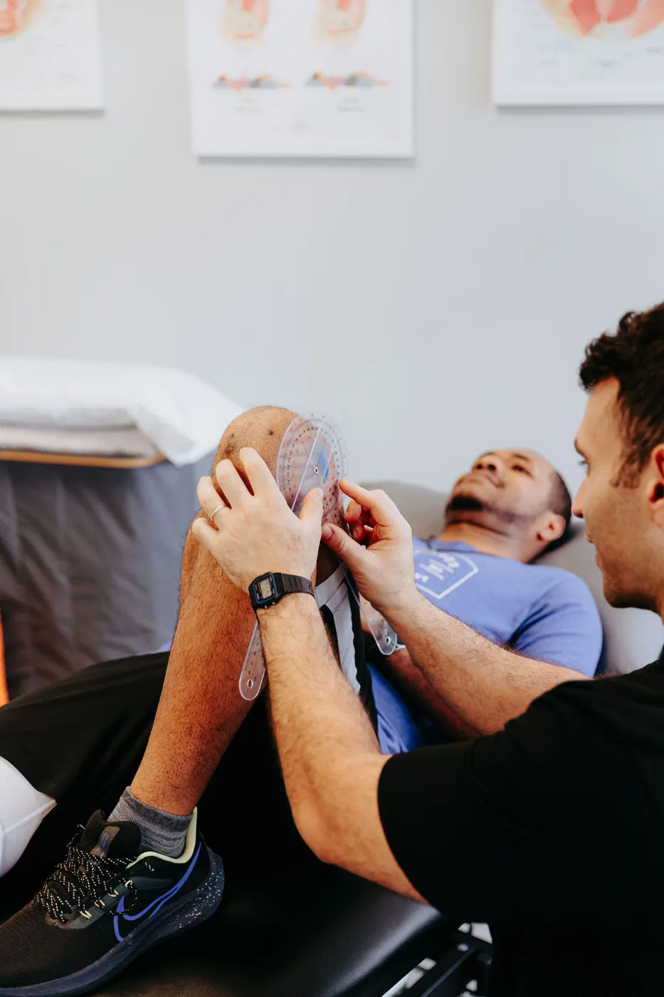 Physical therapist measuring a patient's knee range of motion