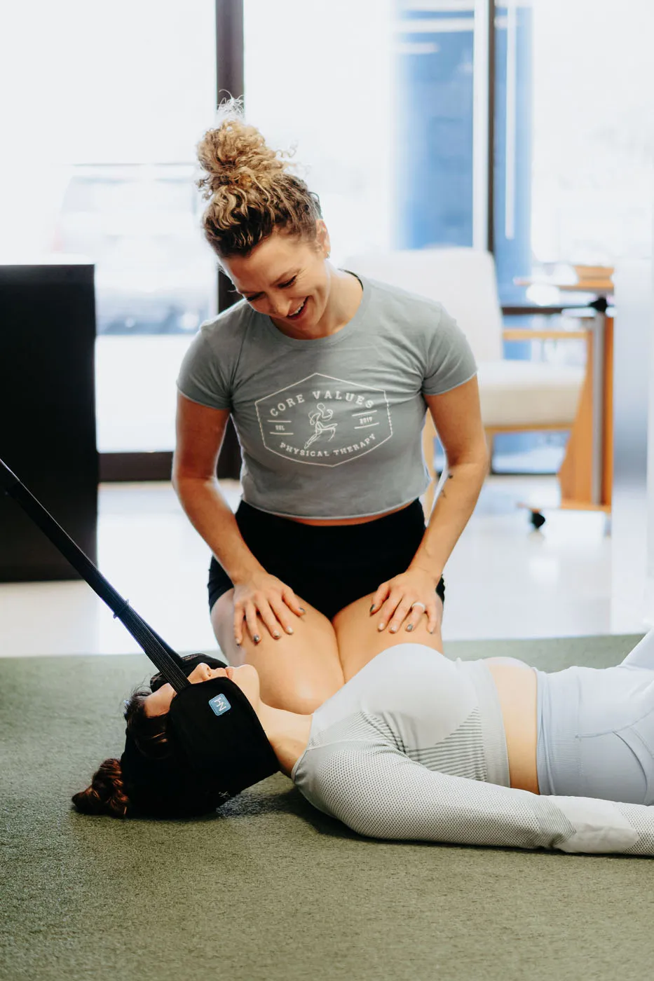 Physical therapist performing assisted cervical traction on a patient