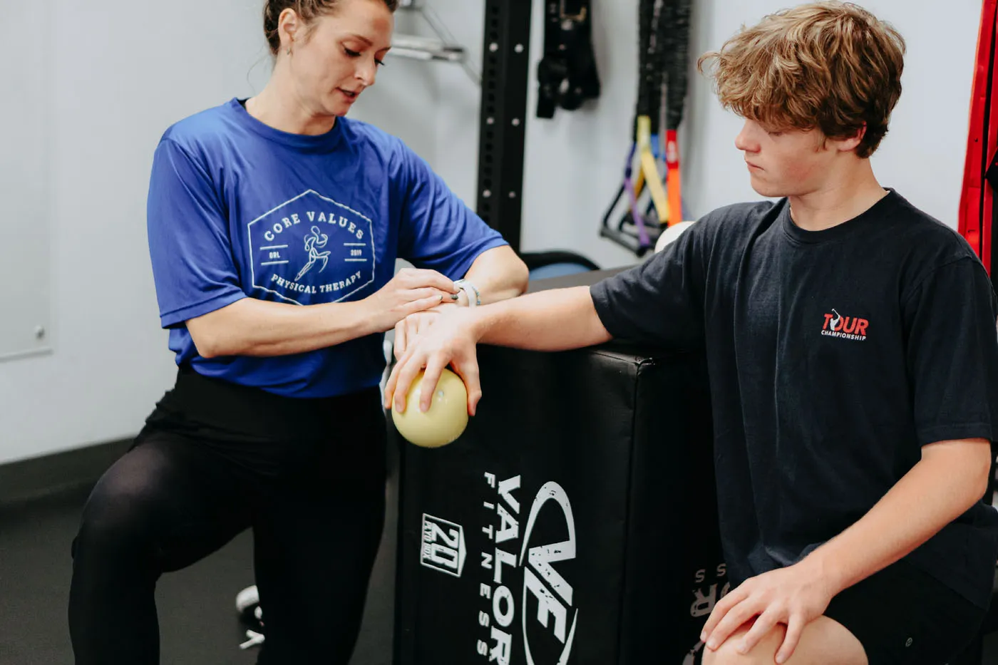 Patient performing a medicine ball hand exercise during physical therapy
