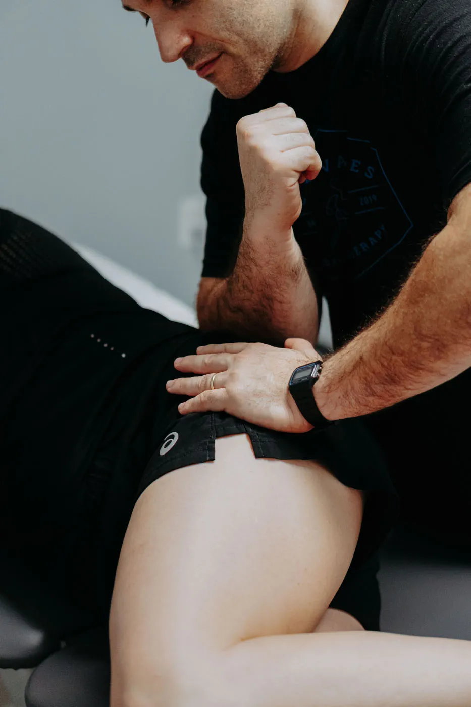 Physical therapist performing a thoracic spine manipulation on a patient