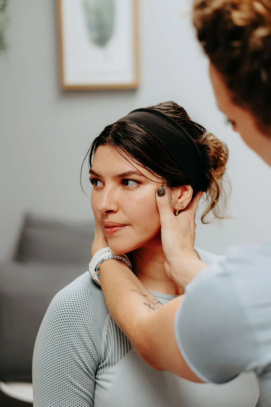 Physical therapist performing a hands-on cervical spine assessment