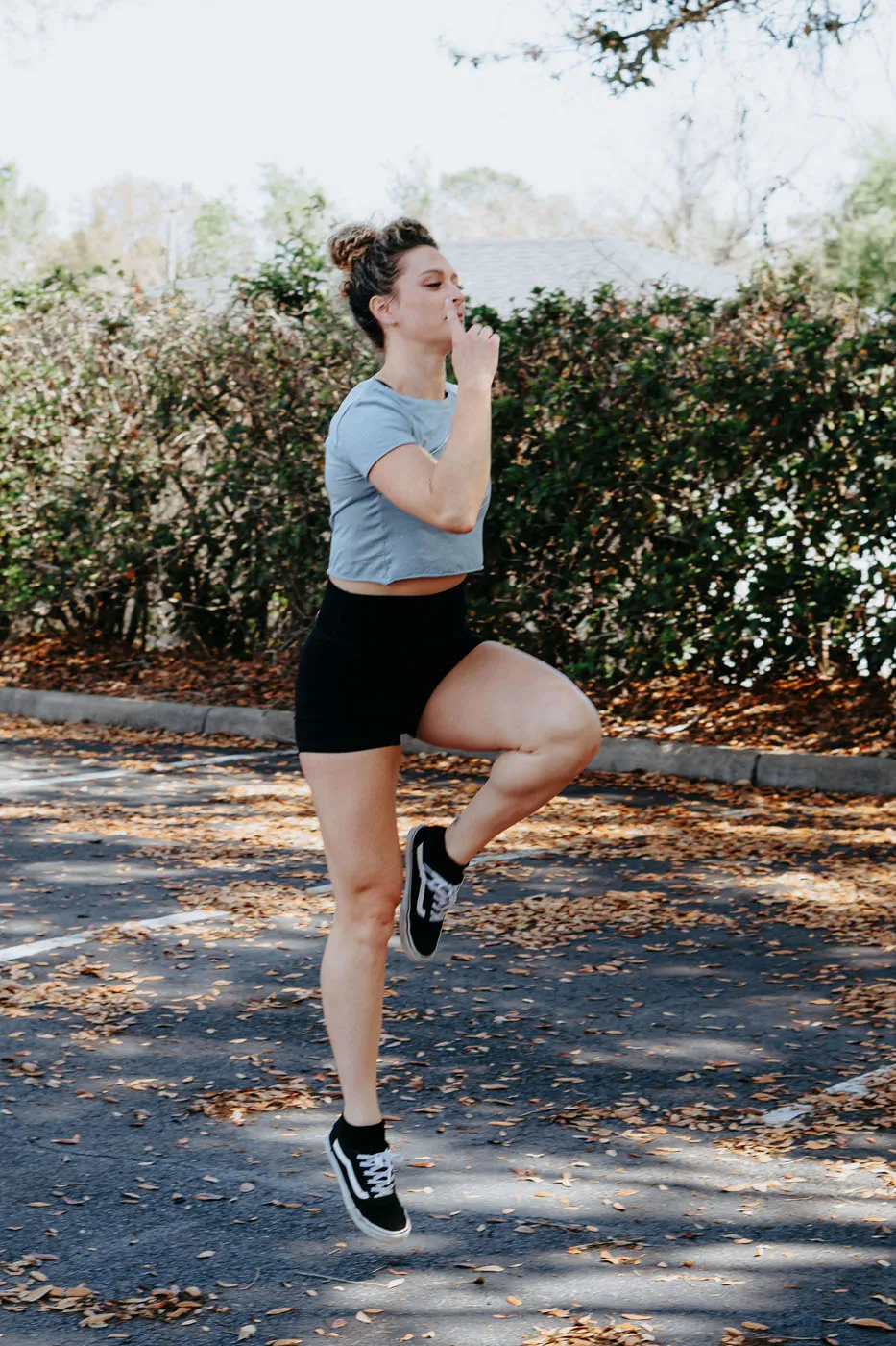 Physical therapist demonstrating proper running form from the side