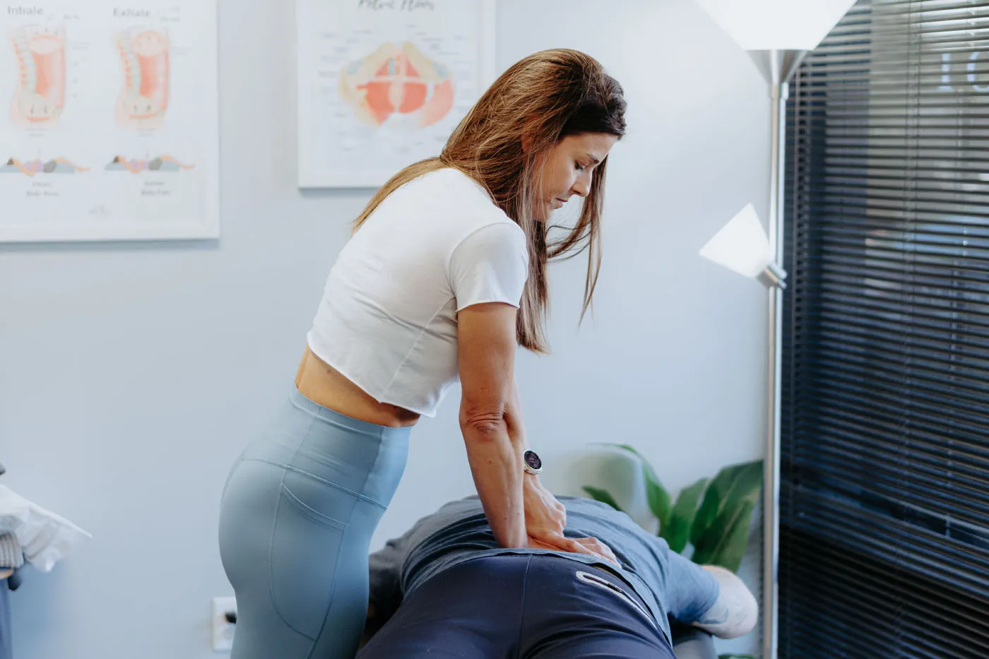 Physical therapist performing deep tissue massage on the lumbar region
