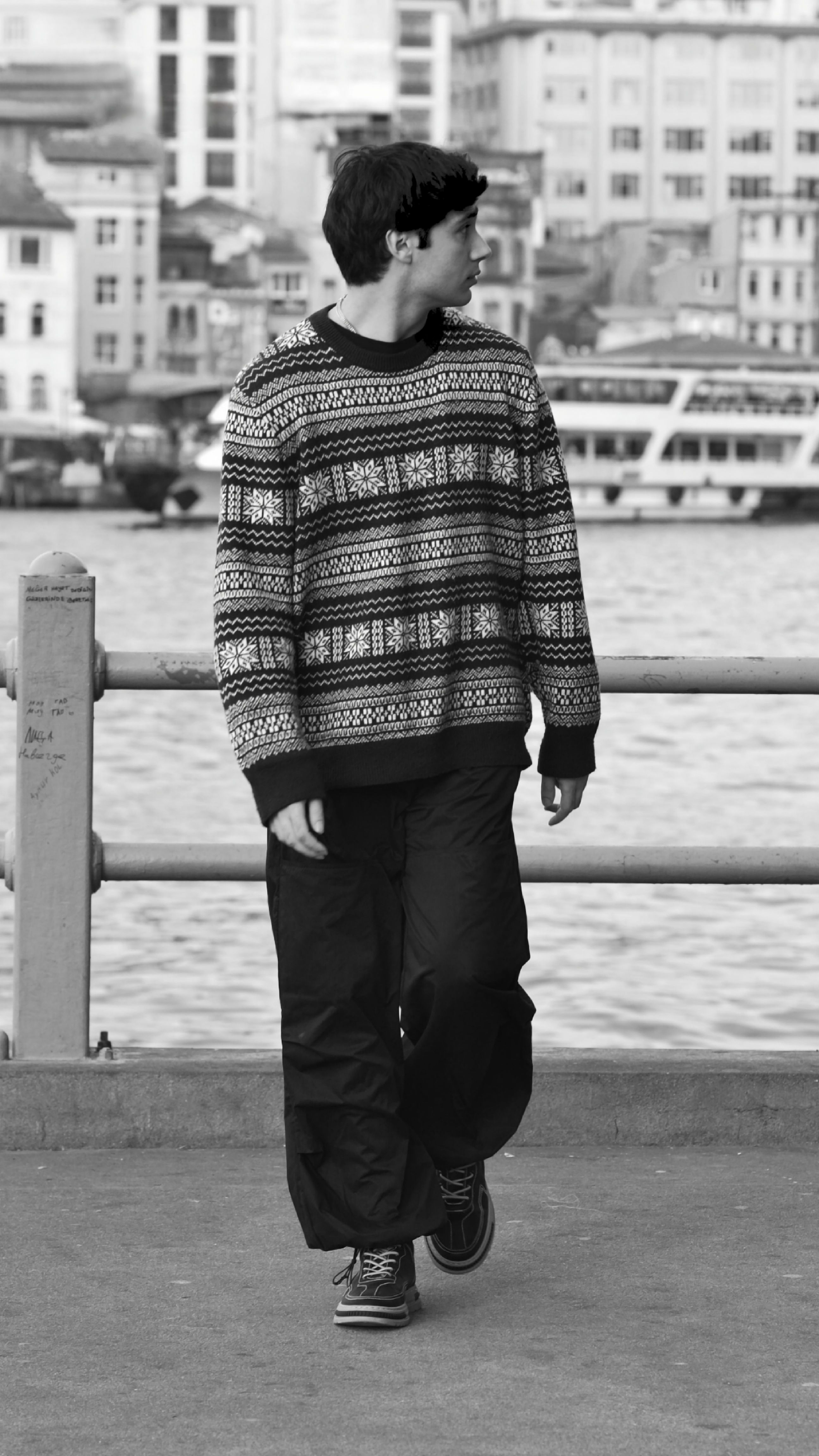 A young man walking along the Istanbul waterfront