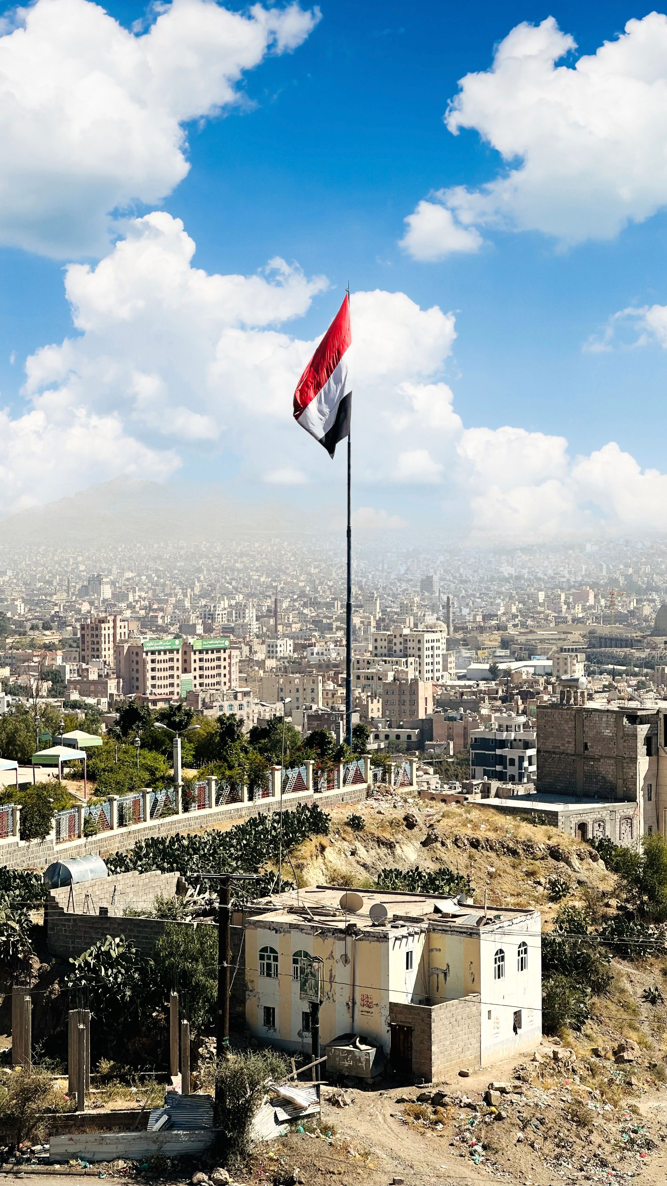 Elevated view of Sana'a with the Yemeni flag