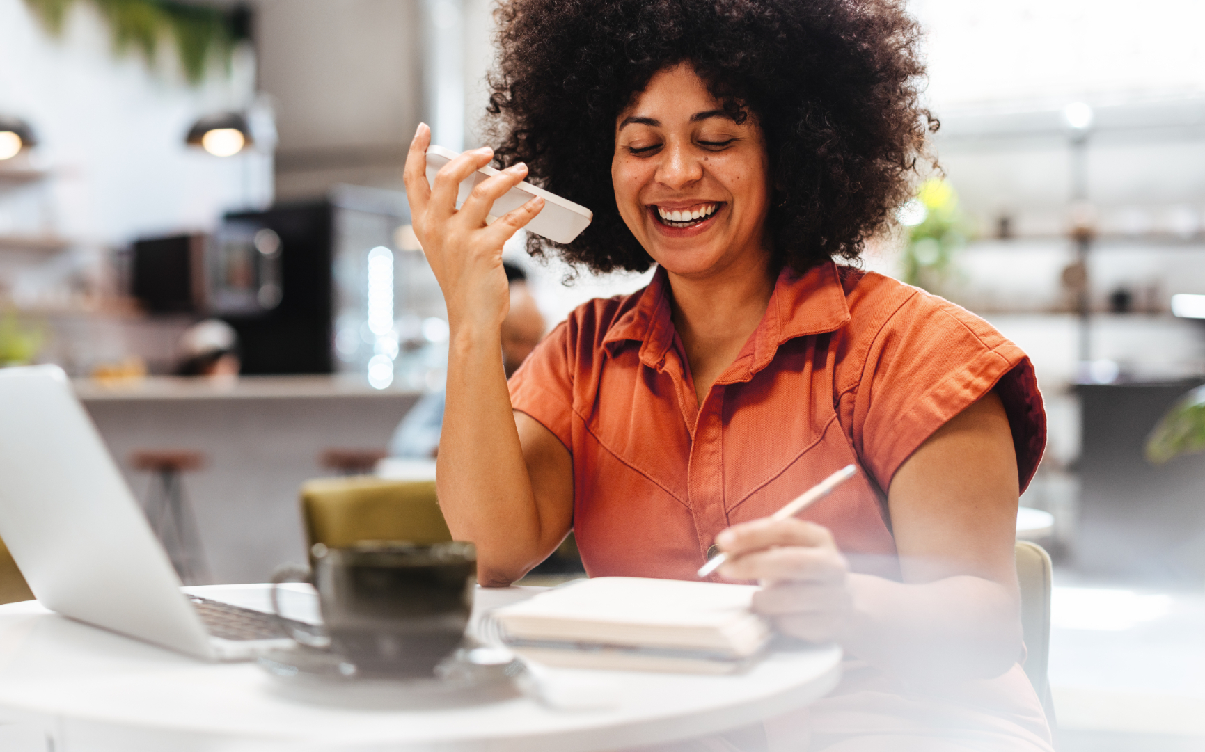 Woman talking on phone and writing stock image
