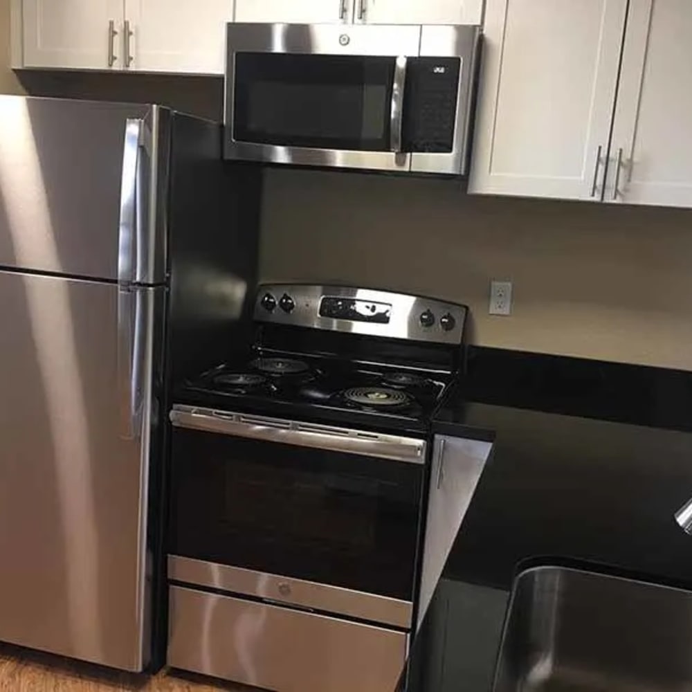 Kitchen with white cabinets and steel appliances