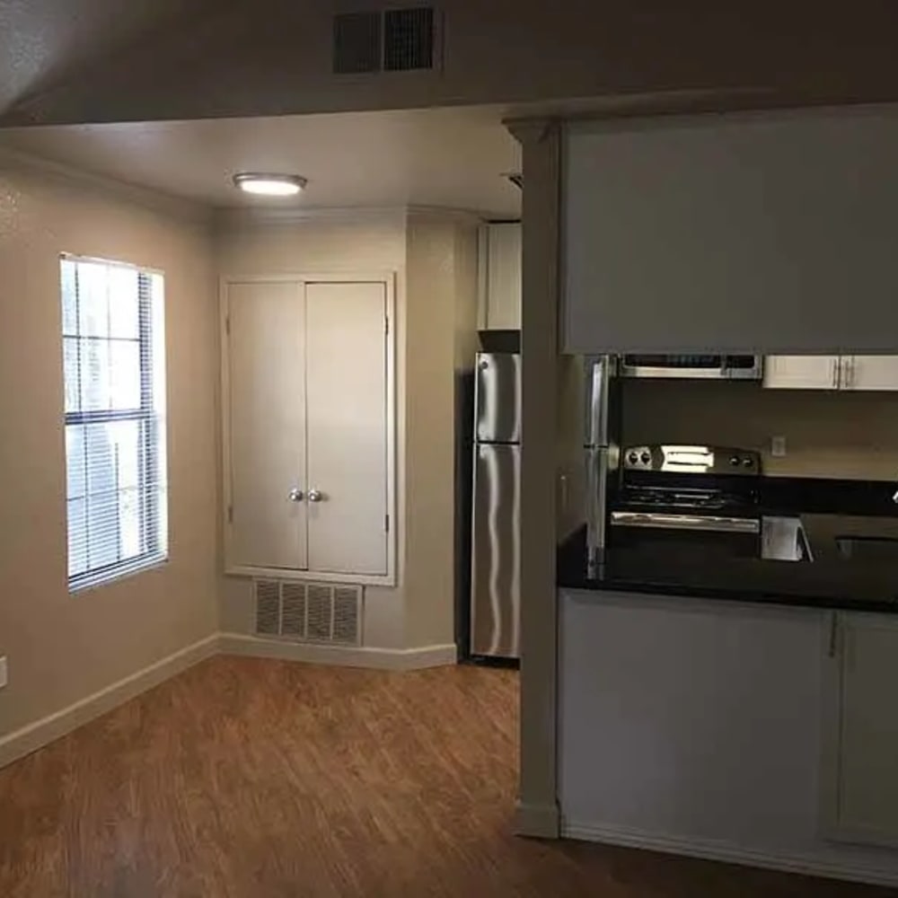 Unfurnished dining area and Kitchen with white cabinets and stainless steel appliances