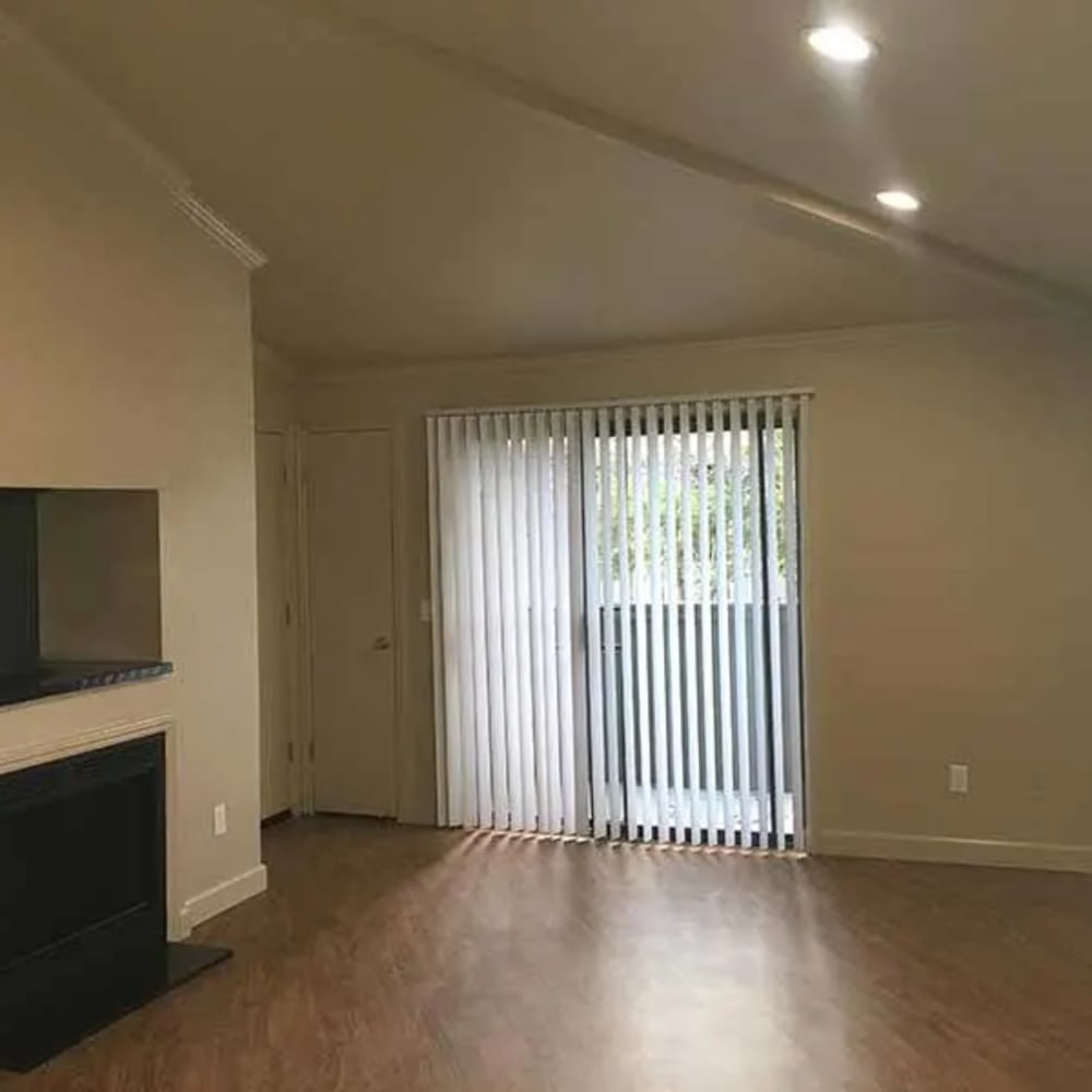 Unfurnished living area with fireplace and sliding patio doors