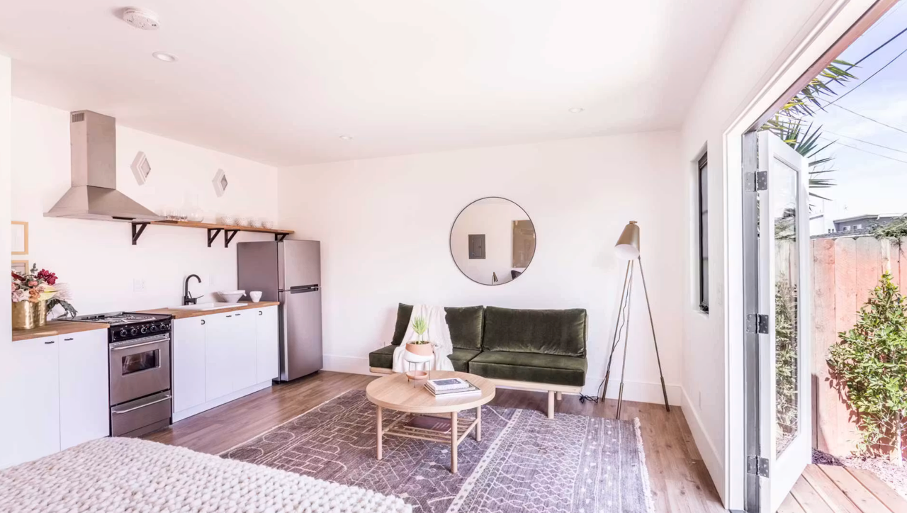 A beautifully designed home, view from the front with inviting entryway, large windows and front garden.
