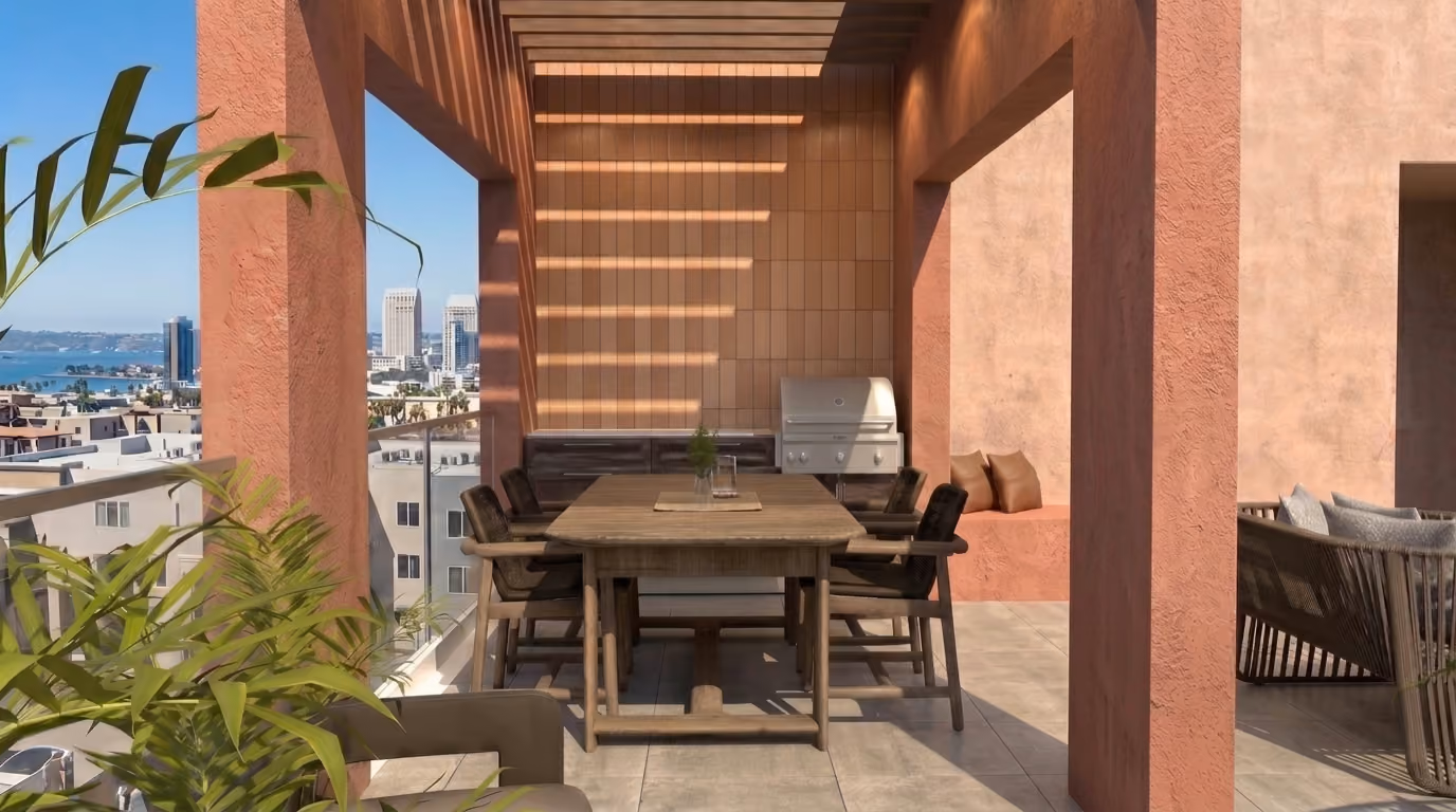 Outdoor dining area under a pergola with wooden table, chairs, built-in grill, and cityscape view.