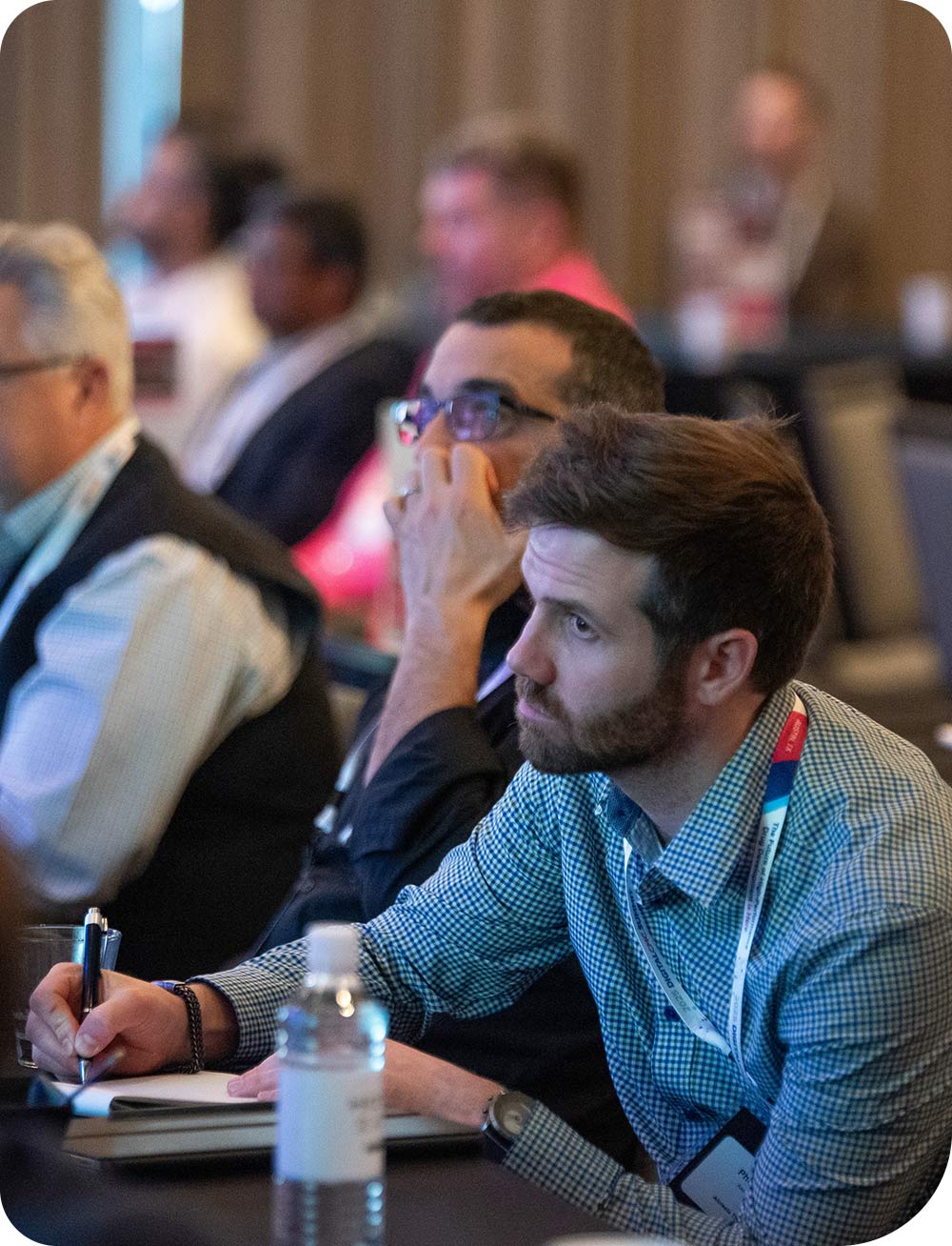 An audience member taking notes at QbDVision's Digital CMC Summit