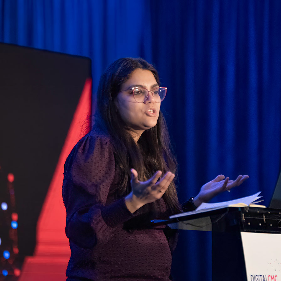 A speaker giving a presentation at QbDVision's Digital CMC Summit