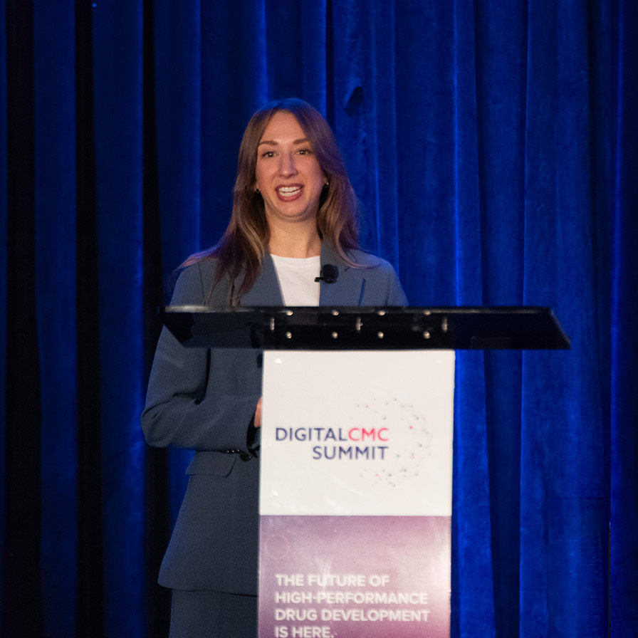 A speaker giving a presentation at QbDVision's Digital CMC Summit