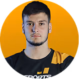 Portrait of a young man with short hair and beard against an orange background.