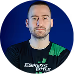 Portrait of a man with short hair and beard wearing a black Esports t-shirt against a blue background.