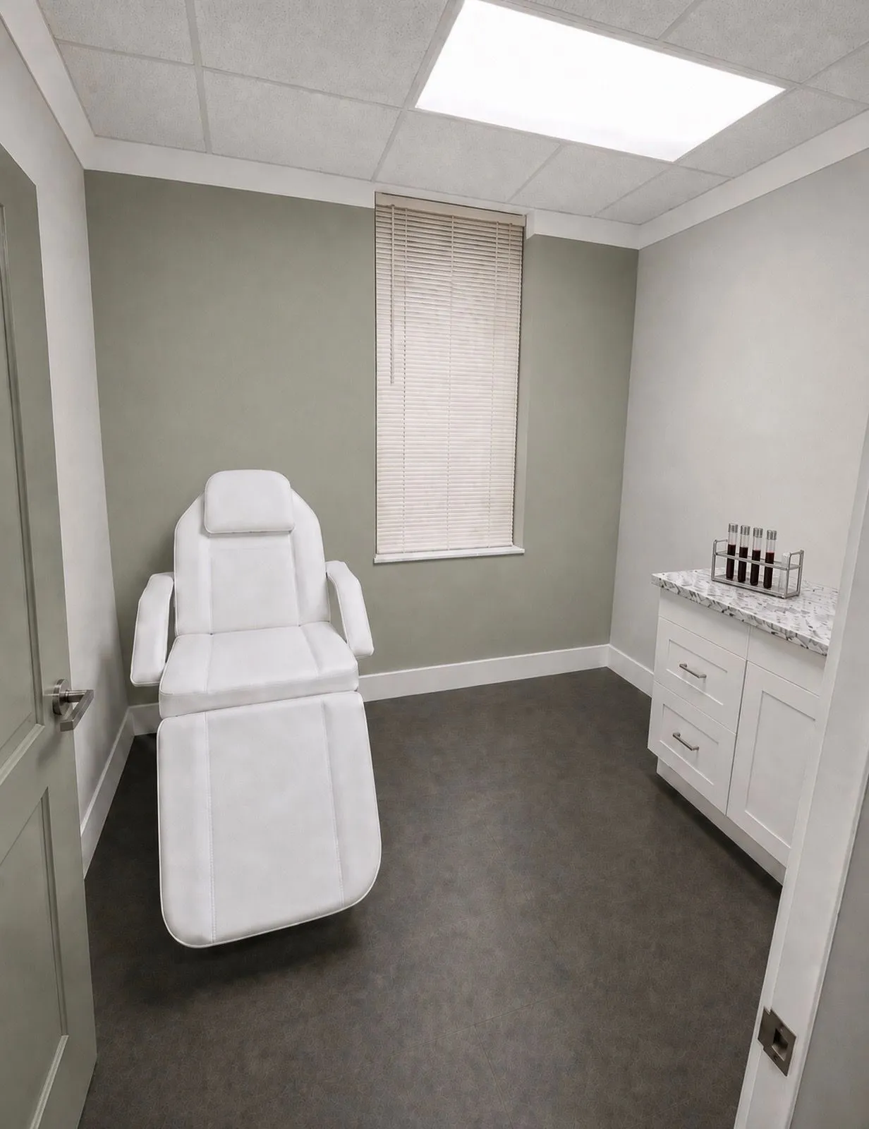 A reclining draw chair and vial rack in a private lab room.