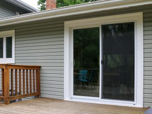 Showcase of sliding patio door with gray color siding