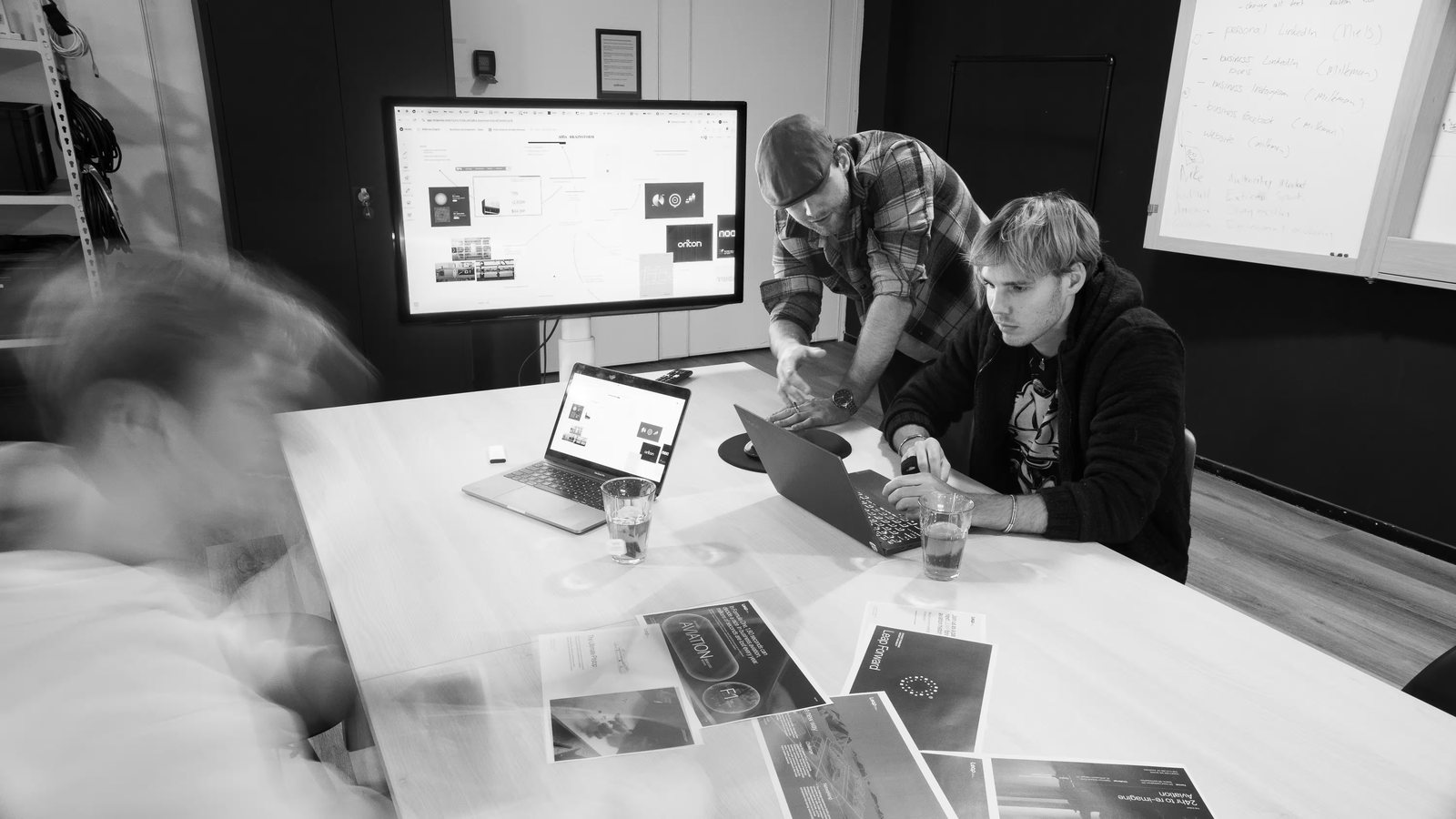 The team reviewing work at the table