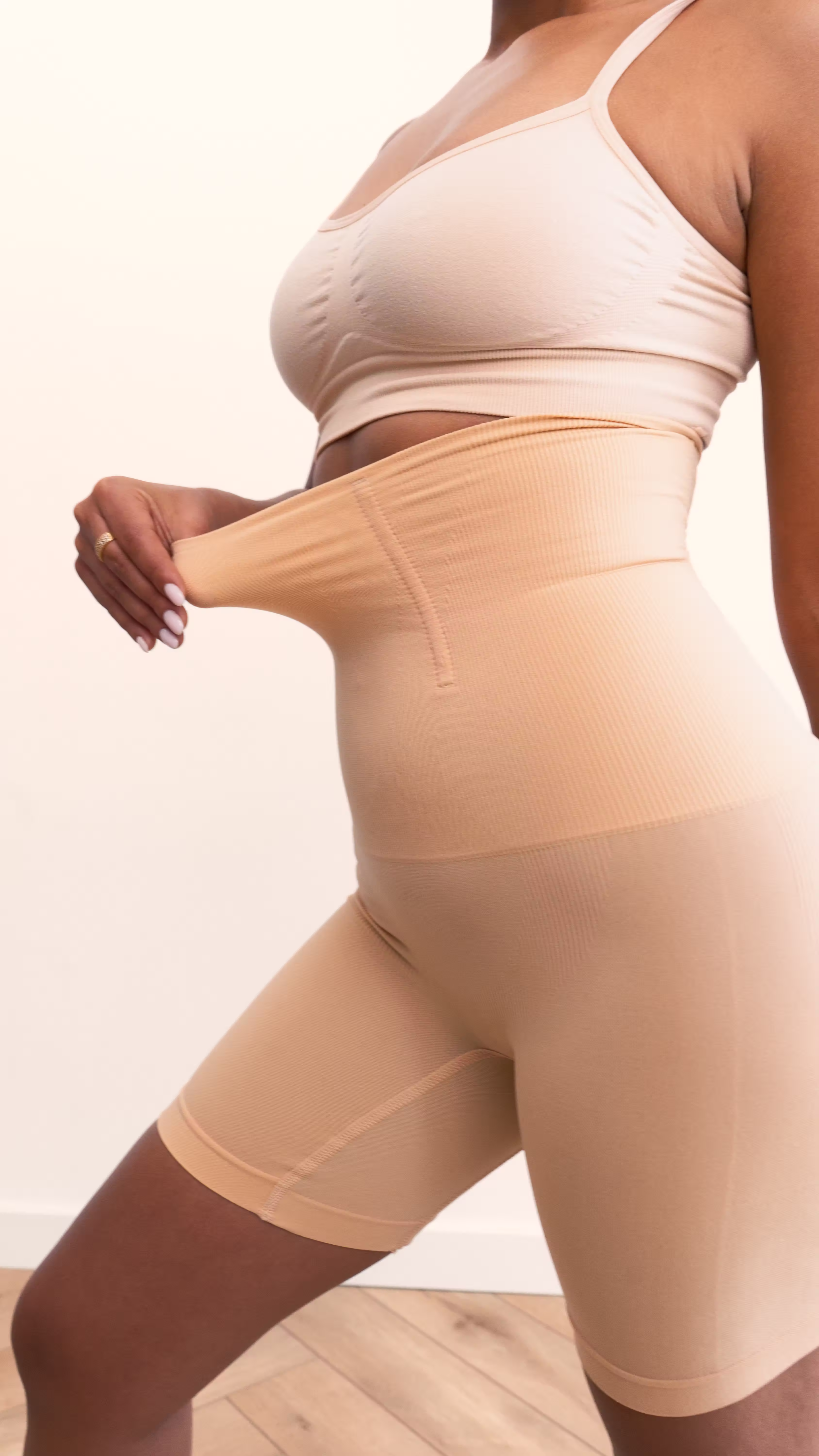 Close-up of nude Essie high-waist compression shorts at the waistband