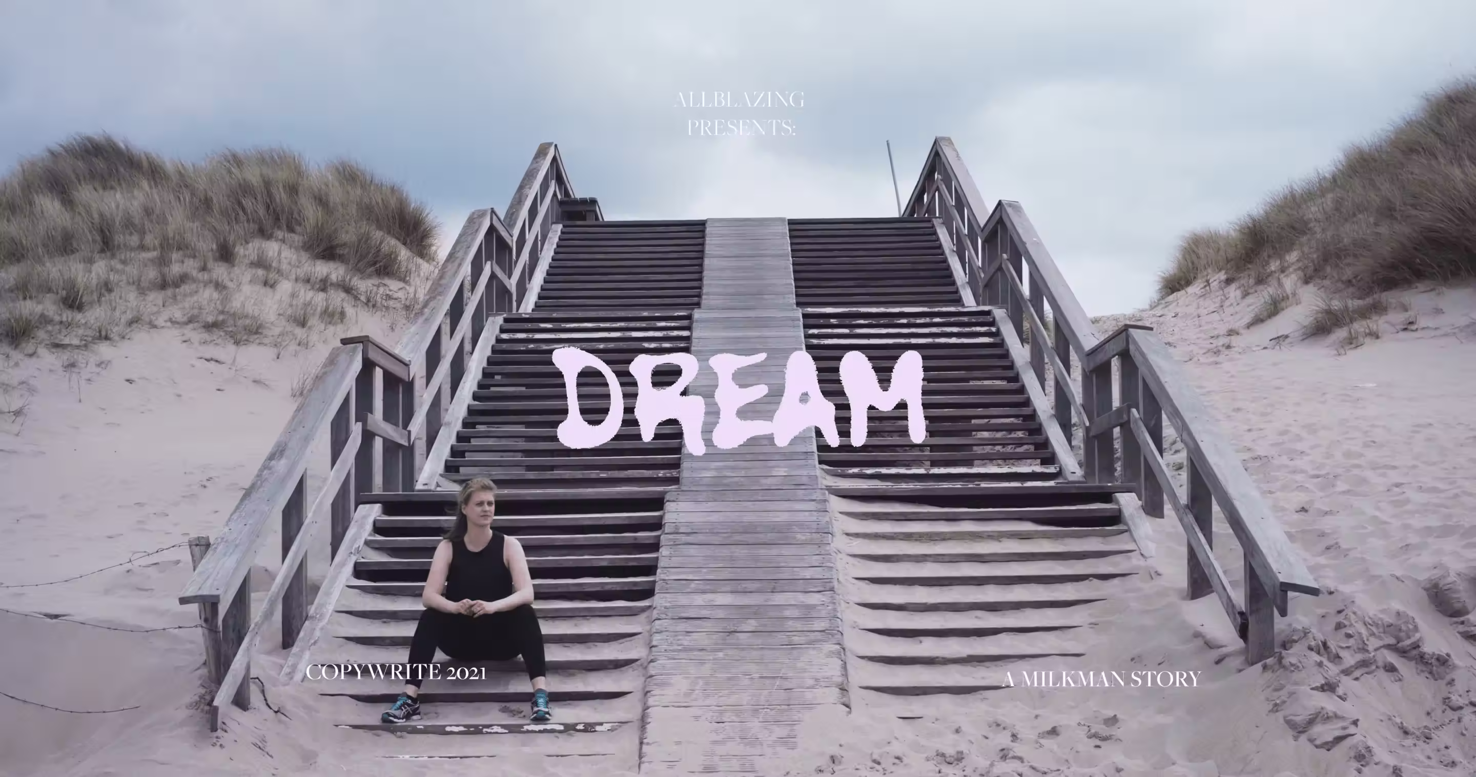 Athlete seated at a beach staircase in the dunes with the word 'DREAM', Allblazing campaign