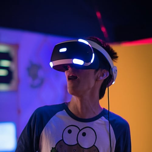 Man testing VR goggles wearing cookie monster t-shirt