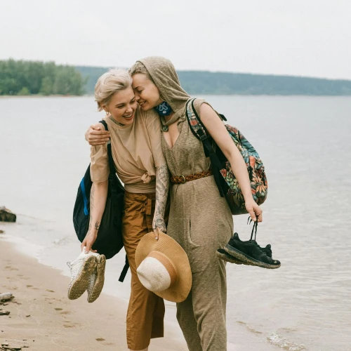 Two happy women embracing beachside