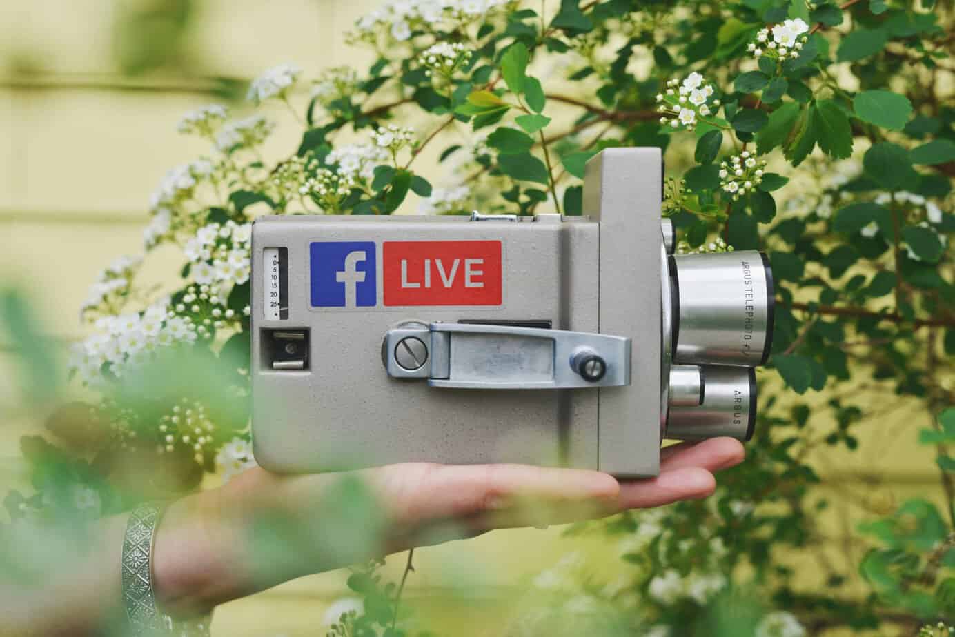 FB Live stickers on old camcorder sat on palm of hand