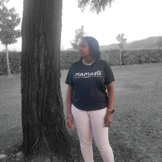 Anitra Jackson in the field standing next to a big tree