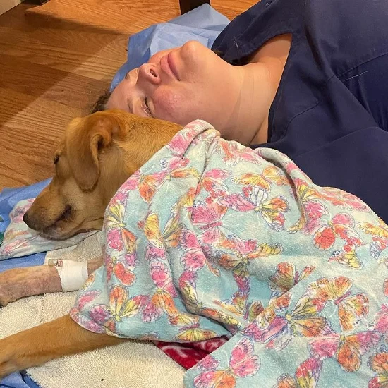 Aleksandra Ascione lying next to her patient after a complicated surgery