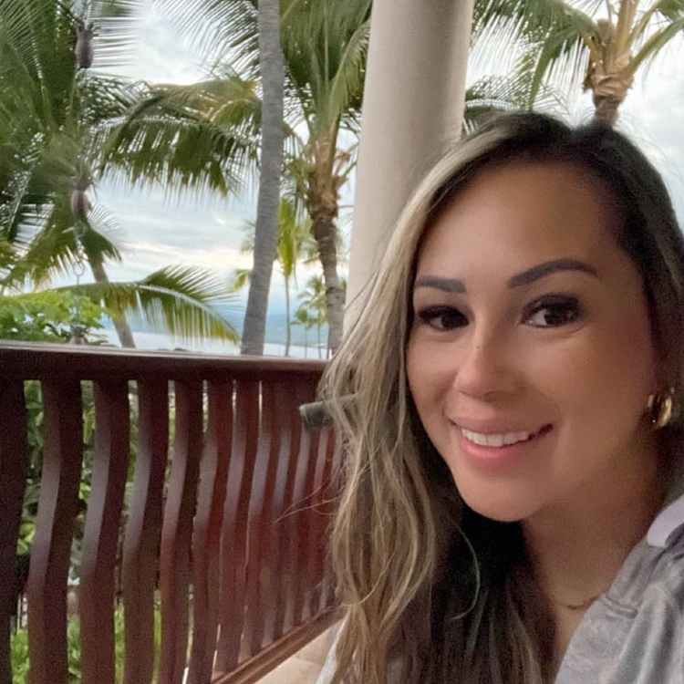 Kirsten Wiggins on a resort balcony by the seaside | Home decor influencers