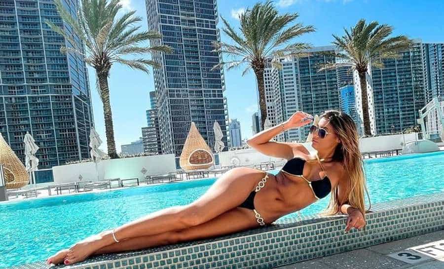 Rachael Staudt laying in the sun by the poolside of Miami hotel