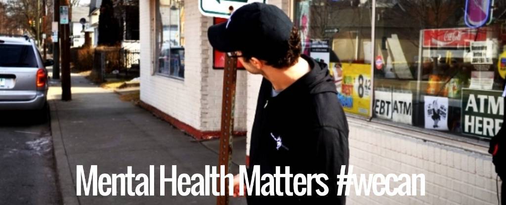 Man with head tilted looking down street | mental health programs