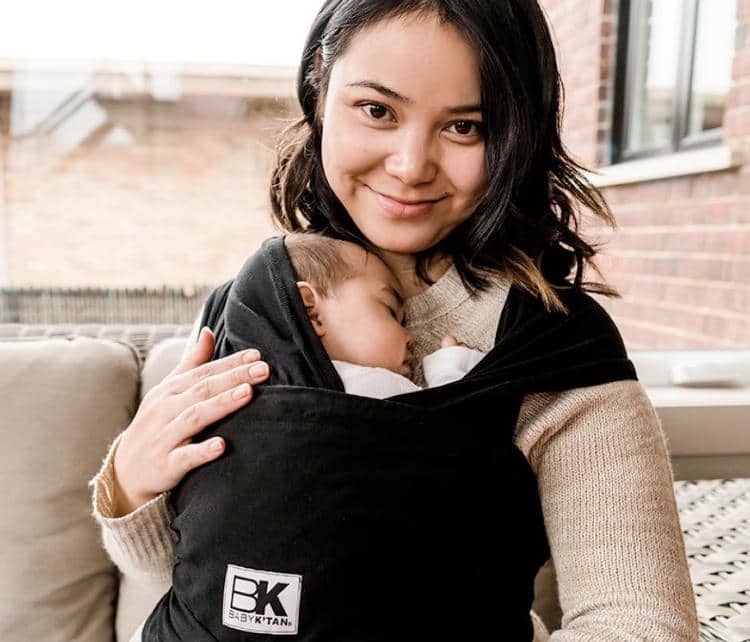 Baby K'Tan | Mommy smiling while cradling baby in carrier wrap