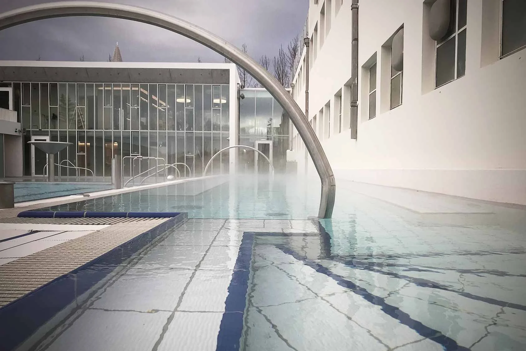 Sundholl reykjavikur swimming pool hot tub area with handrail.
