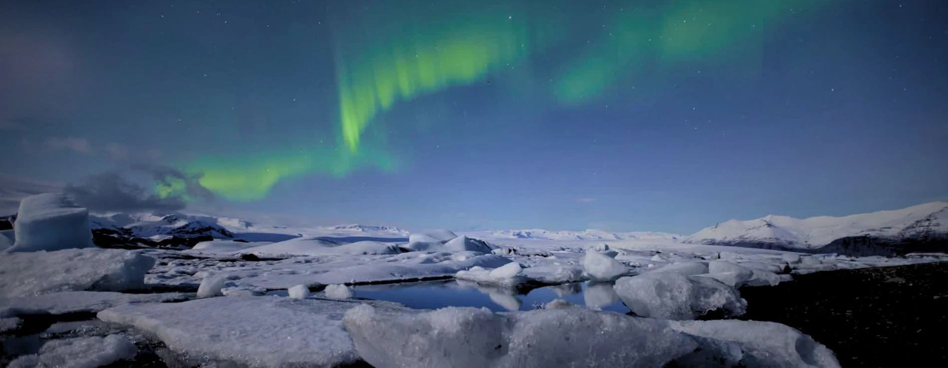 Diamond beach Black Sand Beach under the Northern Lights in Iceland.