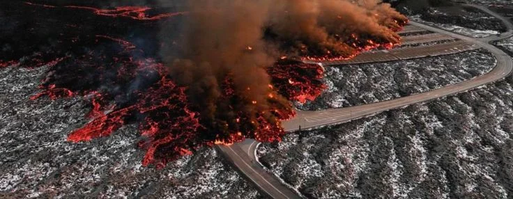 Aerial view of the Blue Lagoon car park under hot lava that flows over it.
