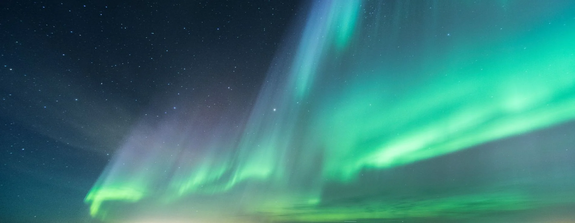 Aurora Borealis in Green color in the night Sky in Iceland.