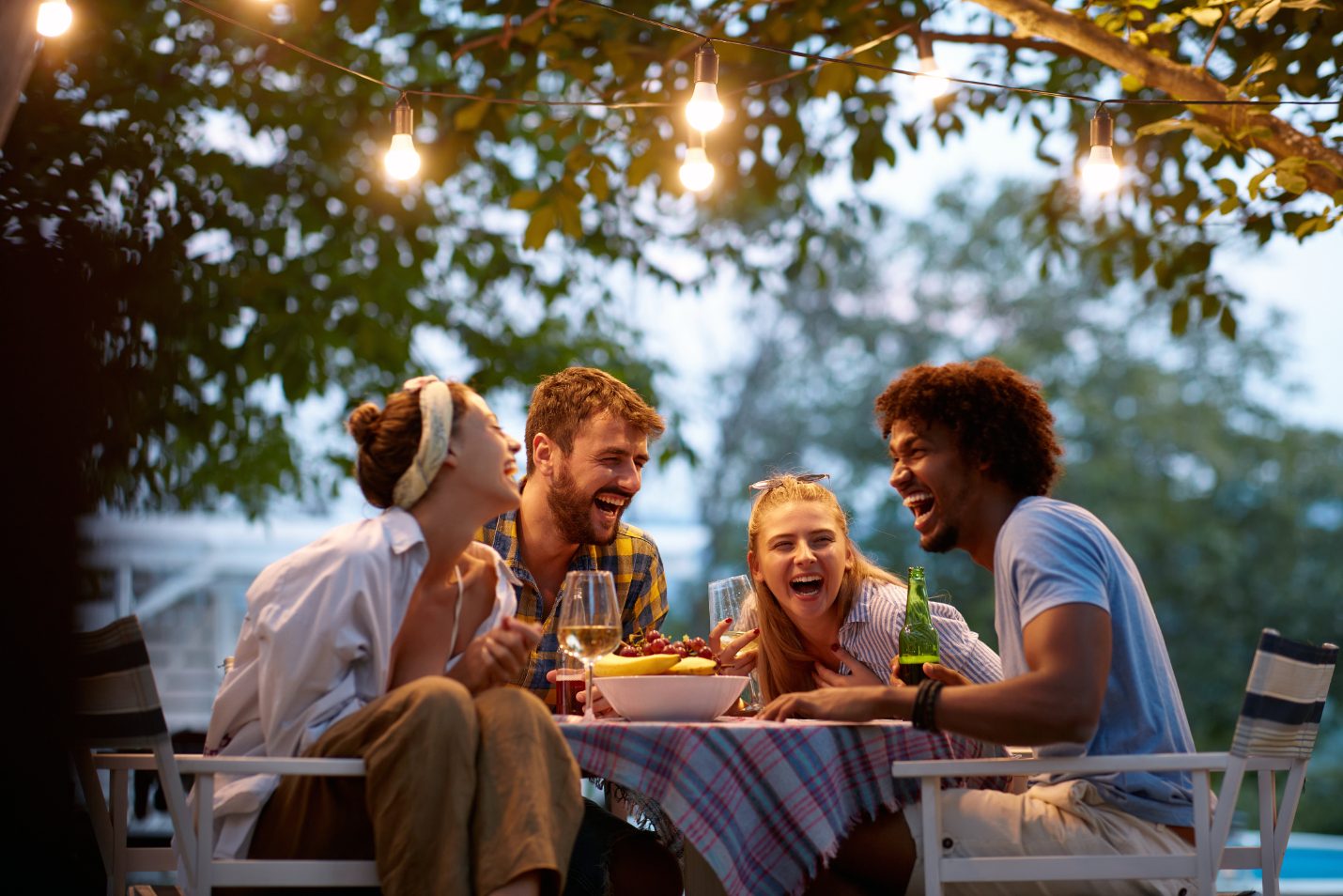 Friends gathered outdoors with food and drinks stock image