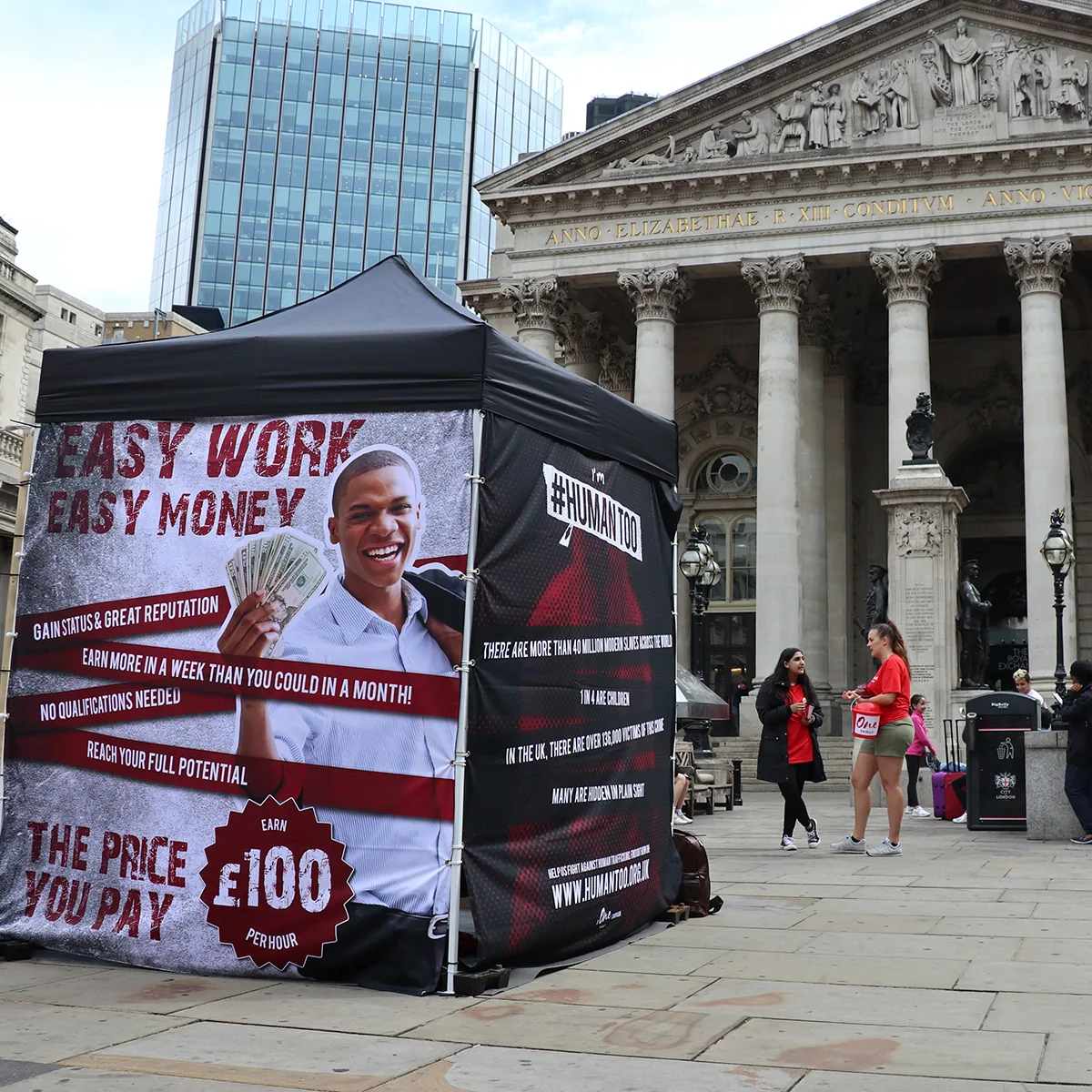 A One Family installation outside the Royal Exchange, wrapped in an Easy work, easy money advert offering £100
