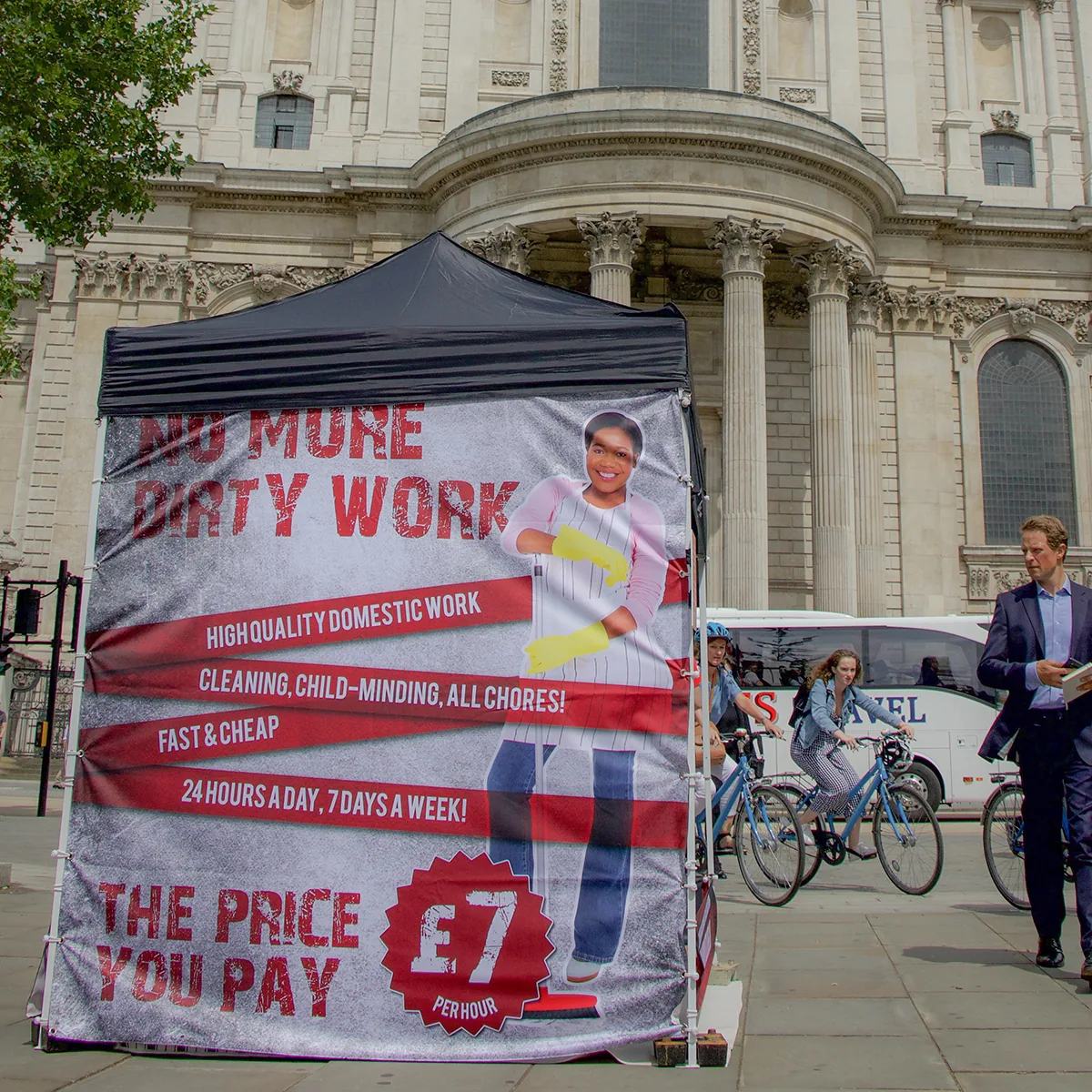 A #HUMANTOO installation outside St Paul’s Cathedral wrapped in a No more dirty work domestic help advert offering £7